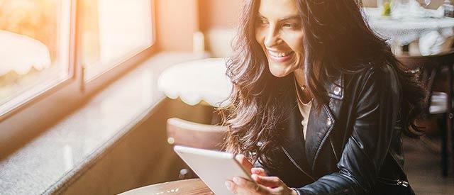 business woman in a coffee shop with a tablet computer